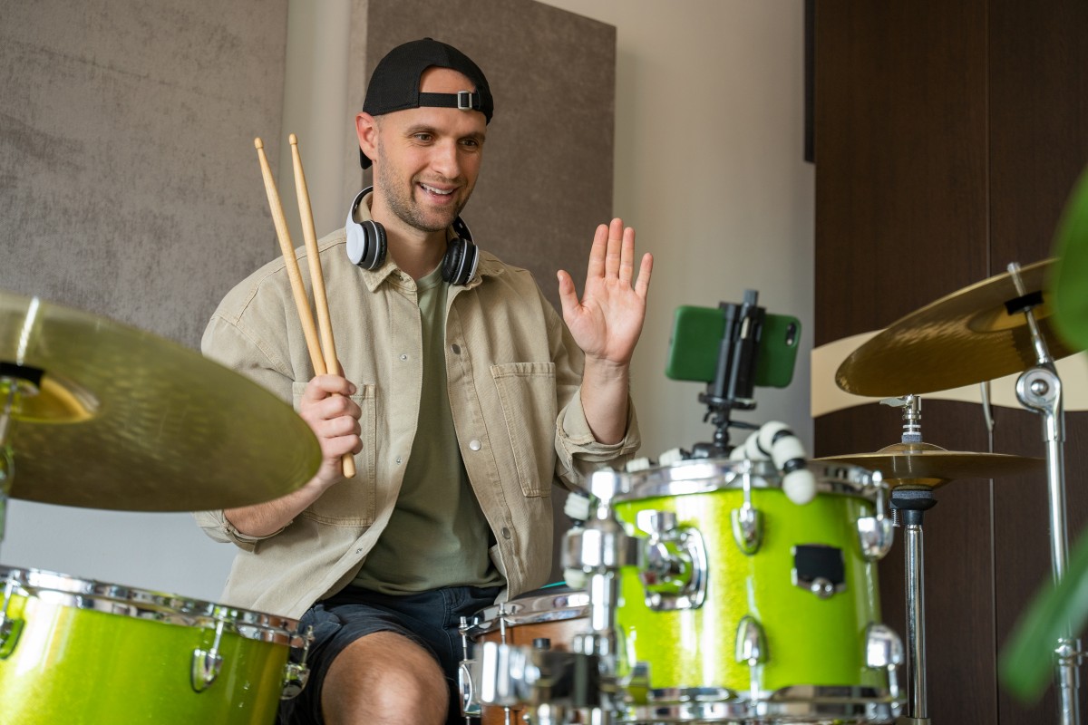 A woman during a Zoom call taking an online Drum lesson